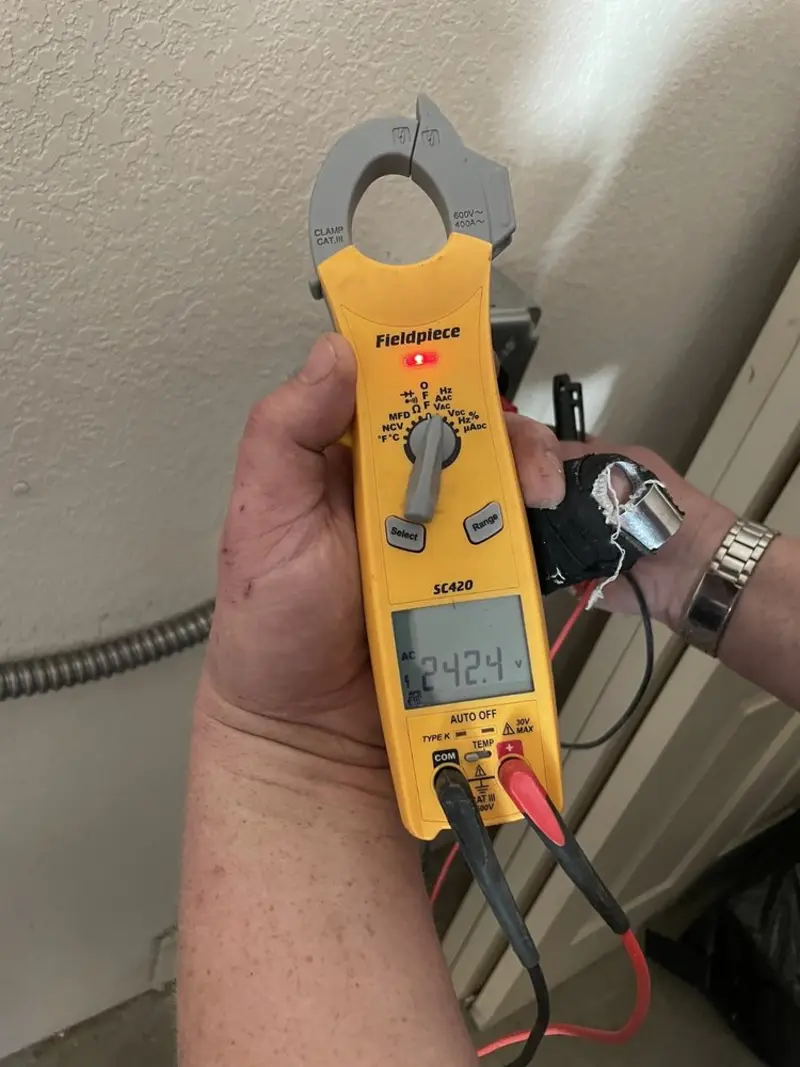 Voltage testing with clamp meter during Recessed Lighting Installation in Cedar Lake